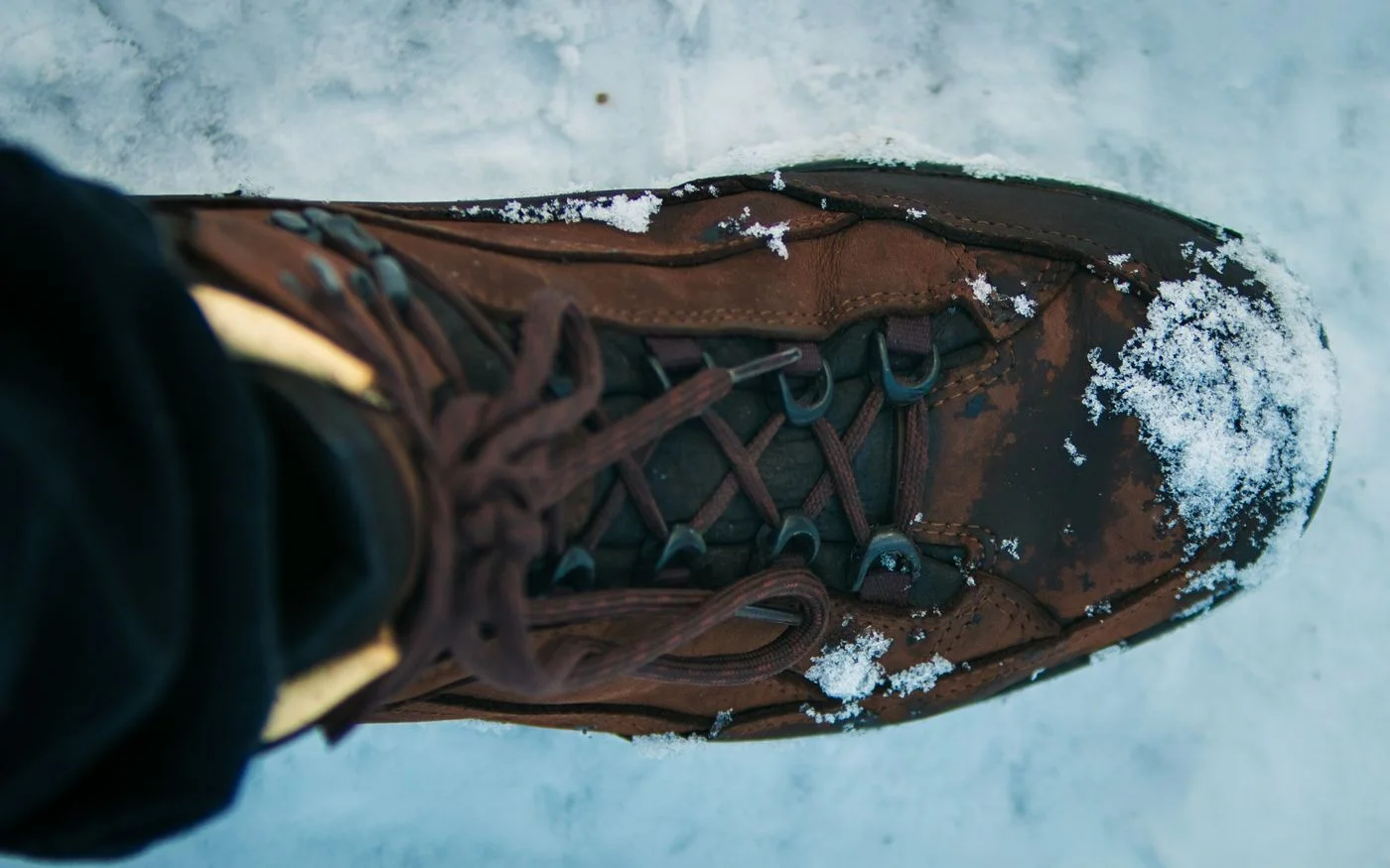 A close view of a laced hiking boot.