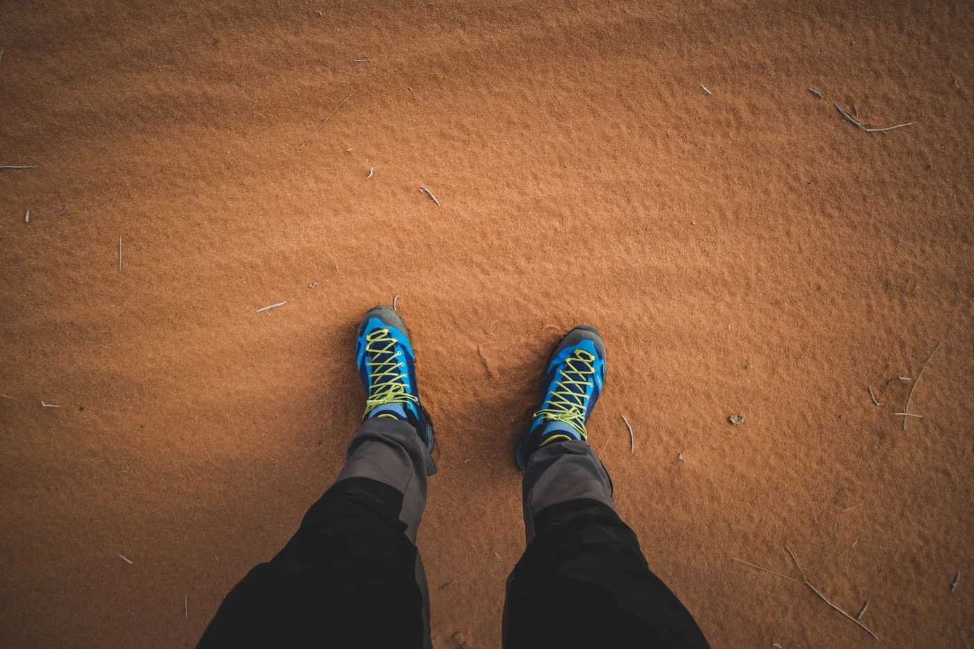 Textile walking shoes on sandy ground.