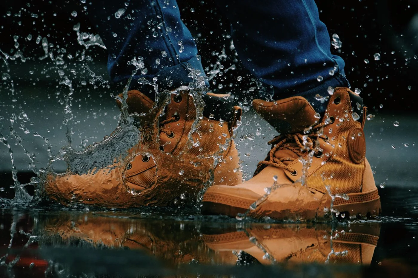 Hiking boots stepping through a puddle.