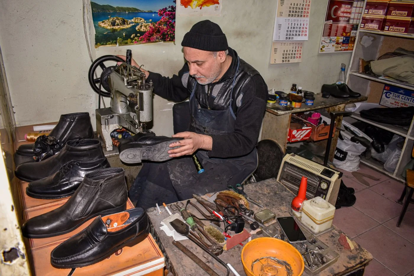 A cobbler working on a shoe sole.