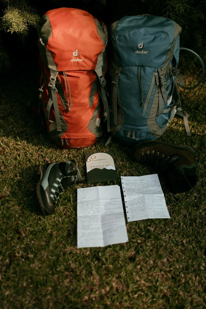 Backpacks and footwear laid out for an outing.