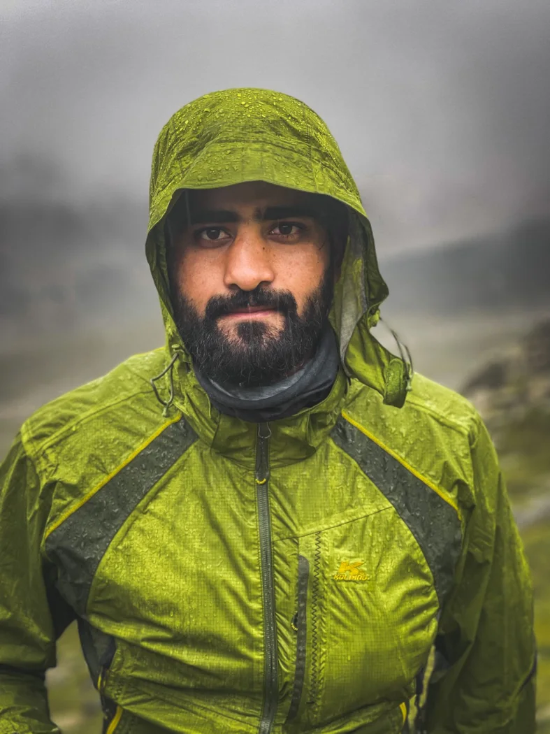 A zipped shell jacket in wet weather.