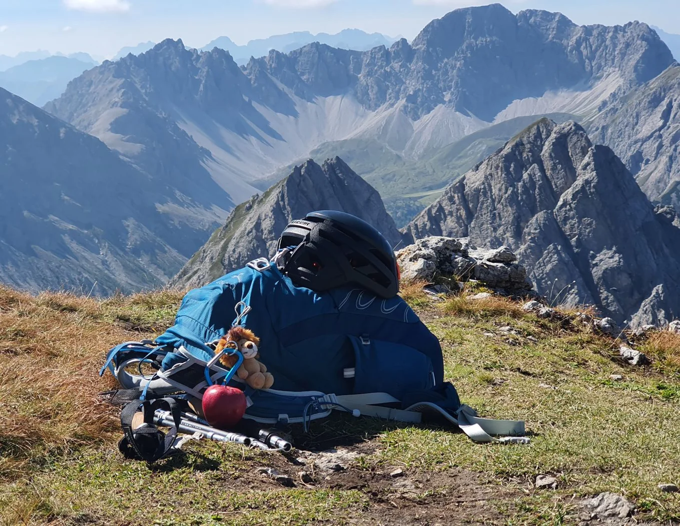 A backpack and equipment at a rest stop.