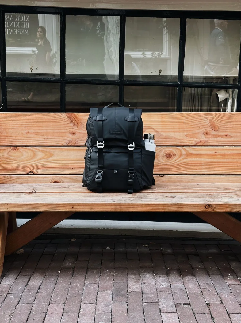 A daypack on a wooden bench.