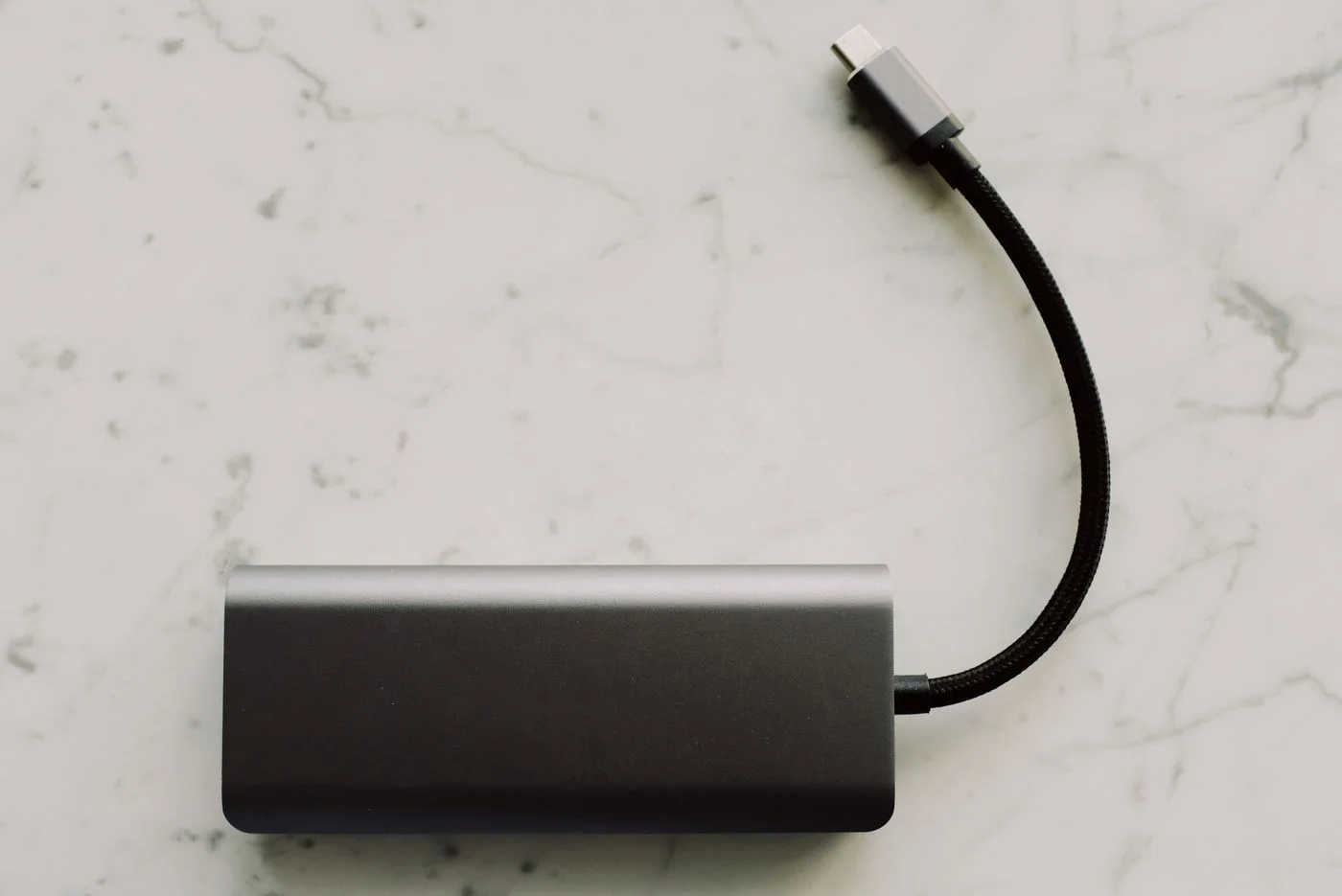 A power bank with a short charging cable.
