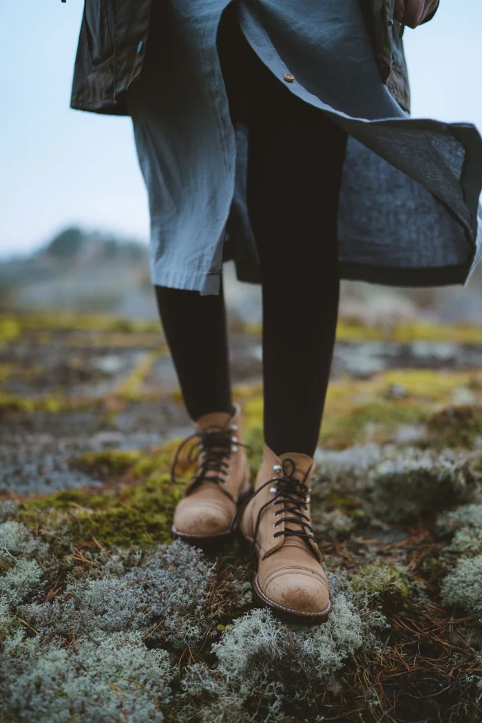 Leather boots on a mossy path.