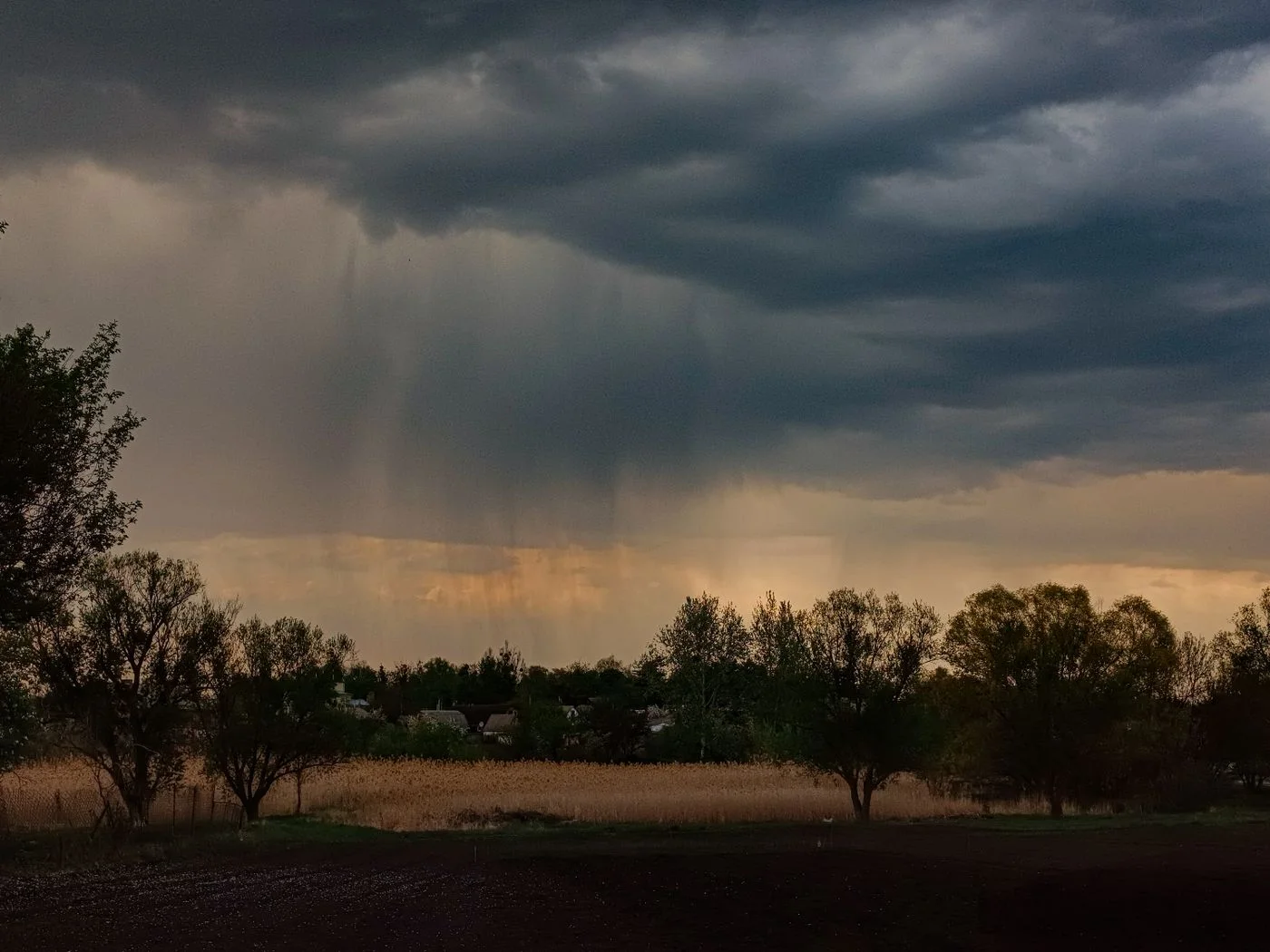 Dark clouds and rain over the countryside.