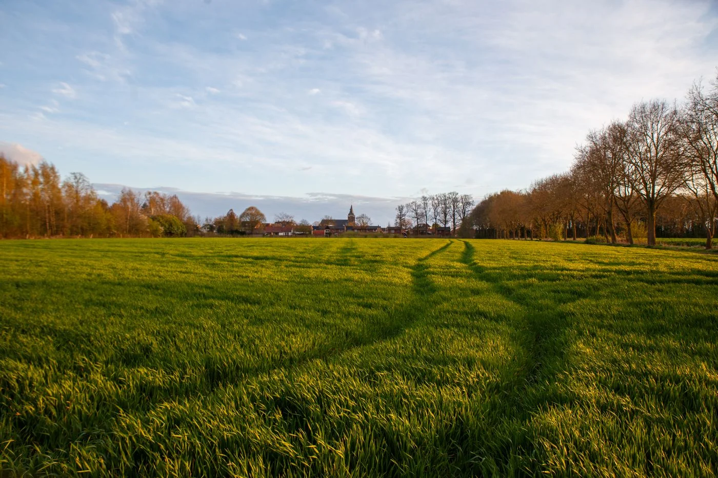 A path between fields and a village.